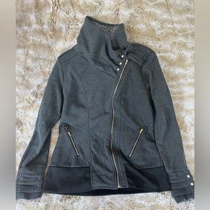 Light jacket, sweatshirt material with zipper and button detail.